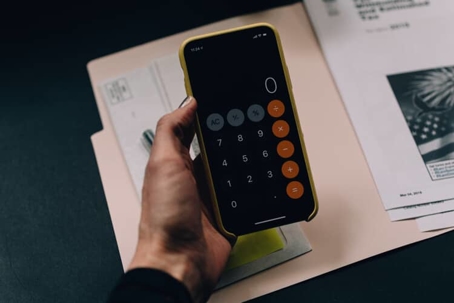Hand holds a cellphone in calculator app