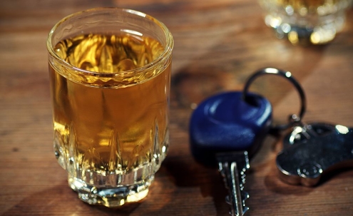 Alcoholic drink and car keys on table